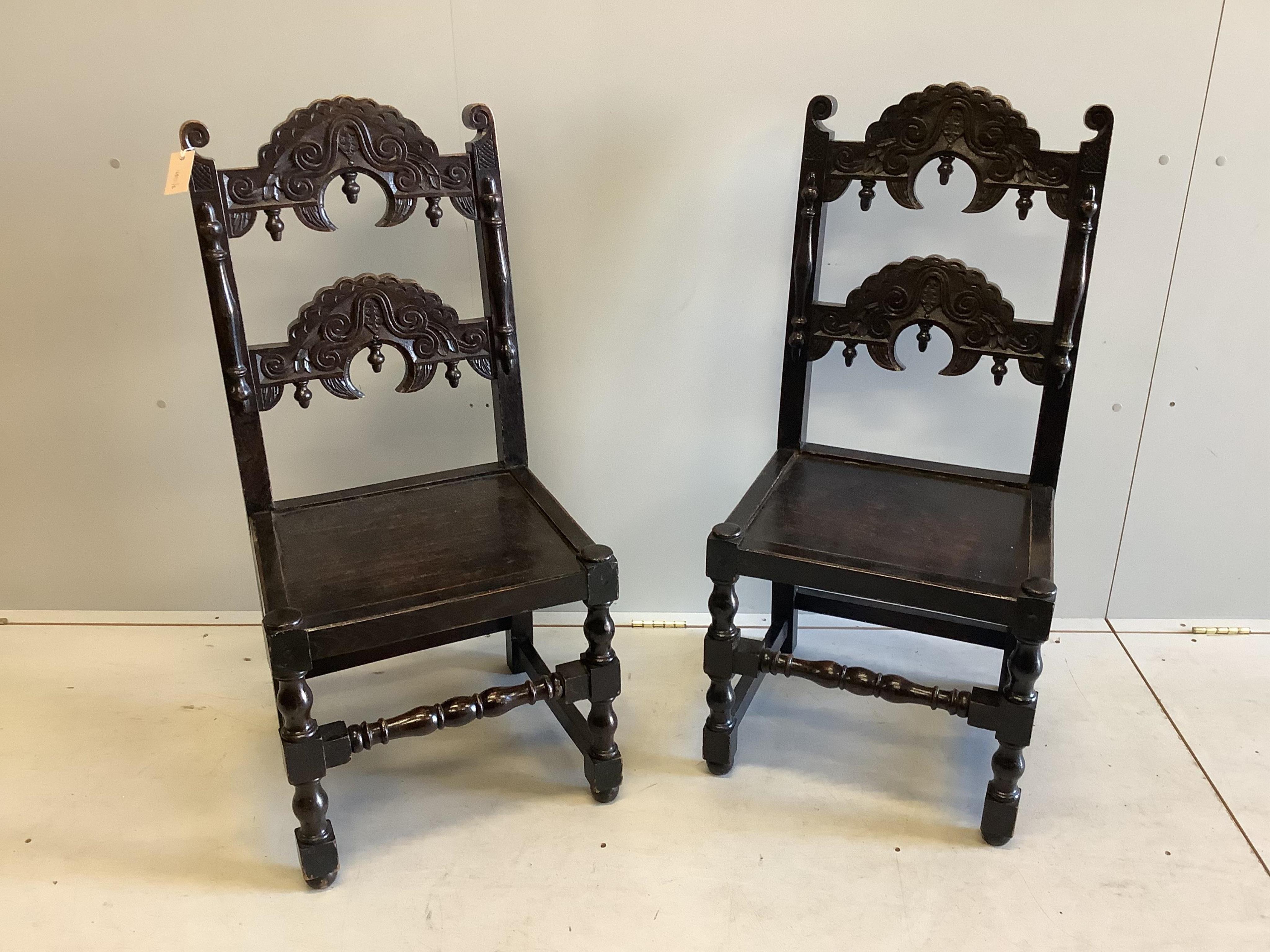 A pair of Derbyshire style oak side chairs, width 48cm, depth 41cm, height 102cm. Condition - fair